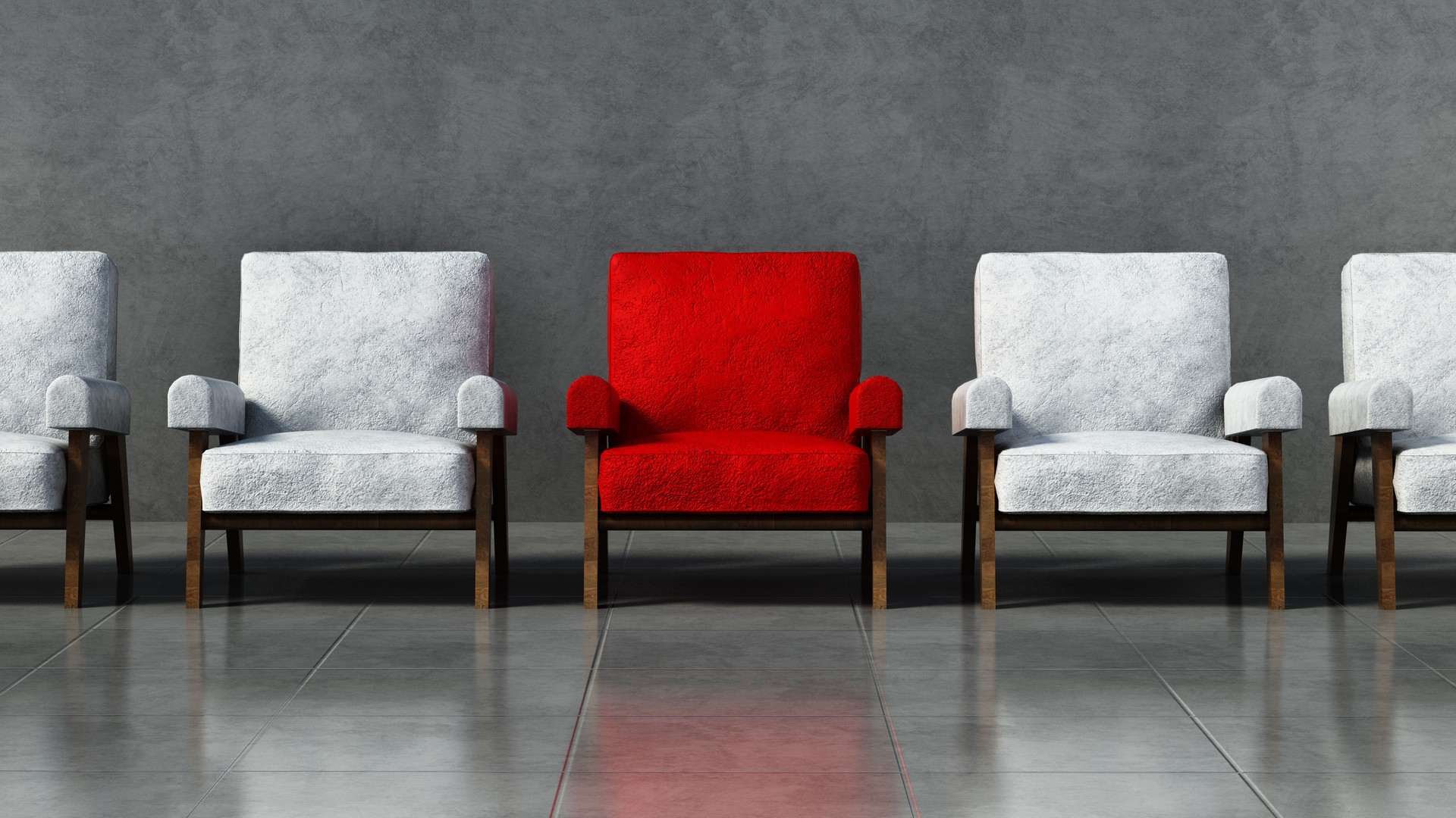 Red chair standing out among white chairs in a room